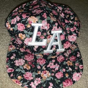 A cute pink cap with flowers and ‘La’ on the top.